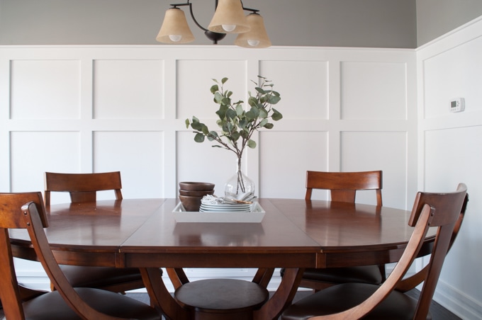 How to define a space with board and batten. A full tutorial for a budget friendly board and batten wall. This completely transformed the look of this dining room.
