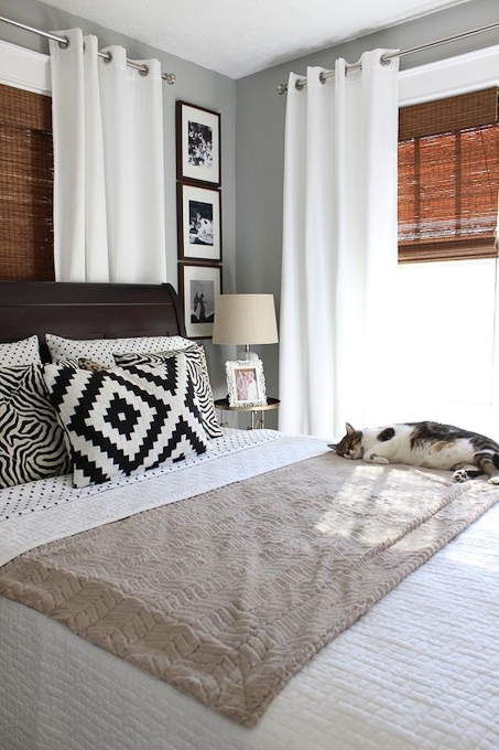 Bedroom with cozy linens and a cat asleep on the bed