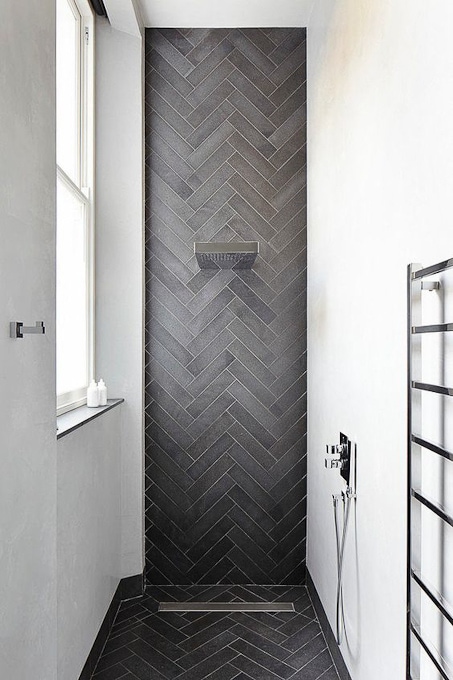 modern bathroom with herringbone gray tile shower