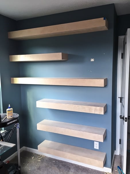 Step by step tutorial for building amazing floating shelves for an industrial masculine office. These only cost her $150 to build!
