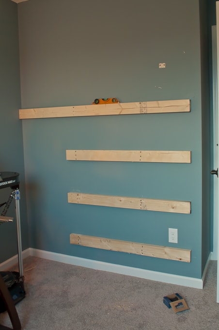 Step by step tutorial for building amazing floating shelves for an industrial masculine office. These only cost her $150 to build!