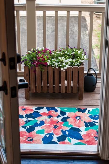 Look at how she decorates this small space townhome porch! Perfect for summer! I love all the bright colors
