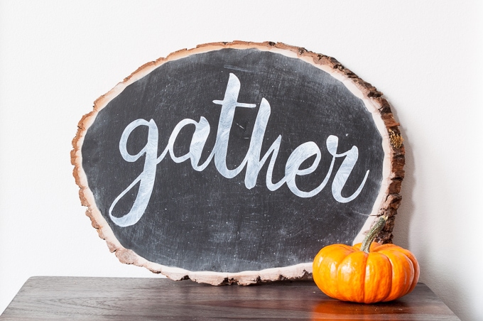 DIY tutorial for this pretty gather chalkboard wood slice sign. Easy way to create hand-lettered chalk designs.