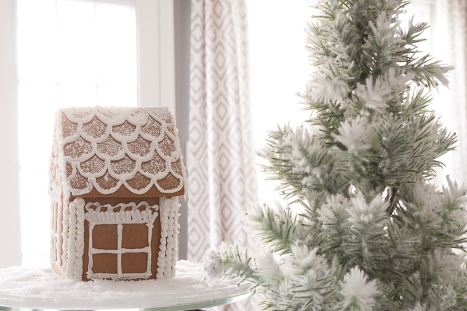 Modern meets Traditional Christmas Home Tour. This pretty white kitchen looks like a whimsical Christmas bakery. Check out the beautiful all white gingerbread house!