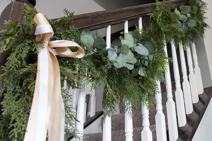 Create this beautiful pine and eucalyptus Christmas garland for your home. It looks so realistic but it's actually fake! I love the mixed green look.