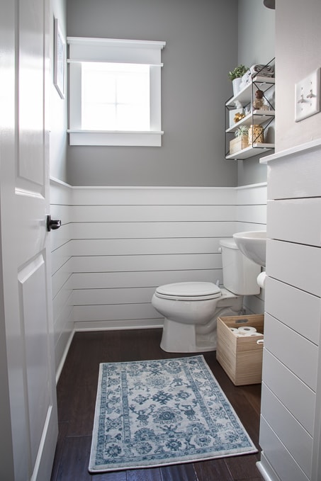 Check out this beautiful powder room reveal! This tiny bathroom was transformed from boring to fresh and modern! I love the shiplap and the modern classic decorations.