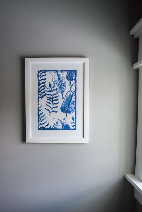 botanical art prints in white frame on bathroom wall