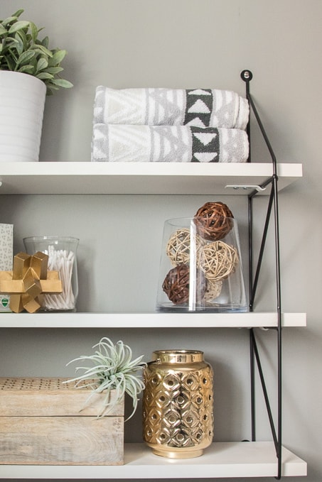 Check out this beautiful powder room reveal! This tiny bathroom was transformed from boring to fresh and modern! I love the shiplap and the modern classic decorations.