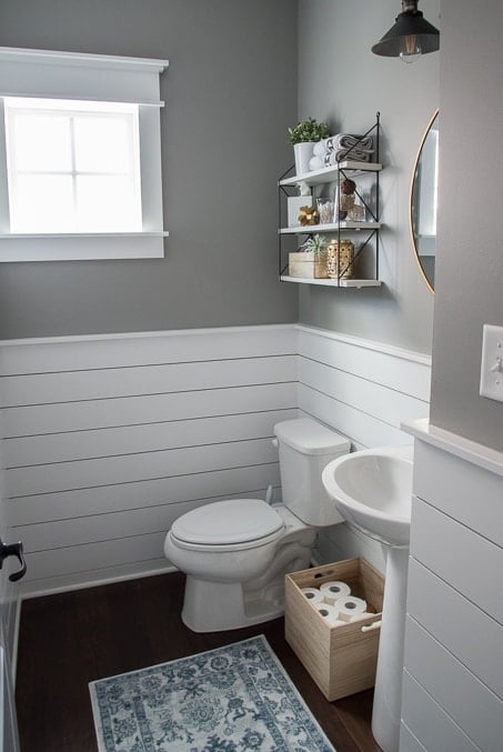 Check out this beautiful powder room reveal! This tiny bathroom was transformed from boring to fresh and modern! I love the shiplap and the modern classic decorations.