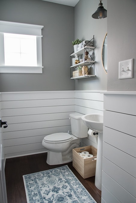 Check out this beautiful powder room reveal! This tiny bathroom was transformed from boring to fresh and modern! I love the shiplap and the modern classic decorations.