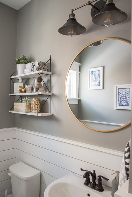 Check out this beautiful powder room reveal! This tiny bathroom was transformed from boring to fresh and modern! I love the shiplap and the modern classic decorations.