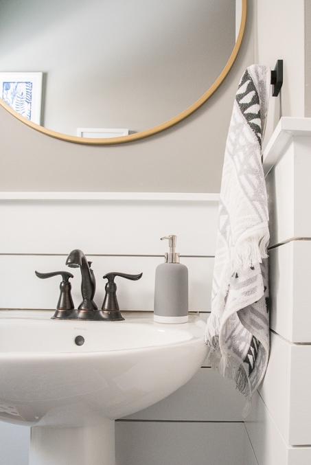 Check out this beautiful powder room reveal! This tiny bathroom was transformed from boring to fresh and modern! I love the shiplap and the modern classic decorations.