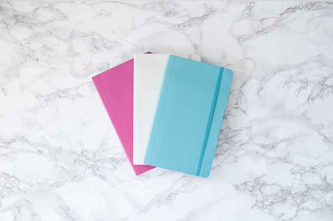 How to make custom notebooks using the Cricut Explore. Learn how to use Cricut Design Space to make these fun notebooks with vinyl, washi, and cardstock!