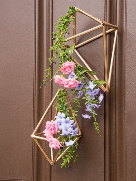 Pretty idea and unique take on a spring wreath! This geometric floral door hanger is gorgeous and a budget friendly way to create a unique spring decoration.