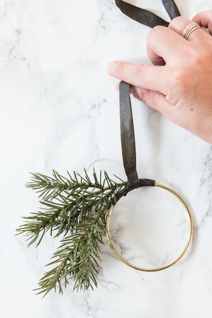 DIY Modern Christmas Wreath Ornament. Create this mini version of a modern gold wreath with faux greenery. Super easy tutorial for a cute ornament.