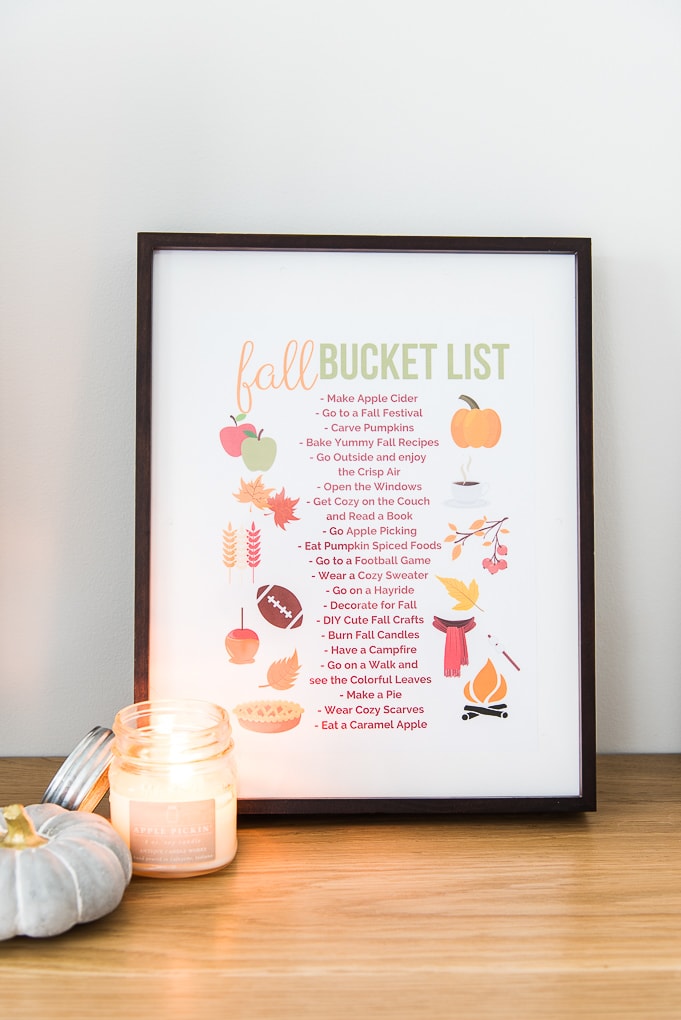 fall bucket list printable in a frame with a candle