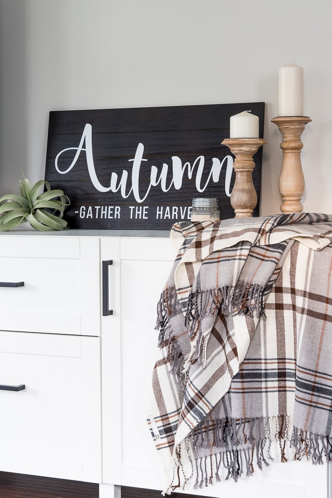 Wooden Autumn Hand-Lettered sign vignette on a media center with accessories