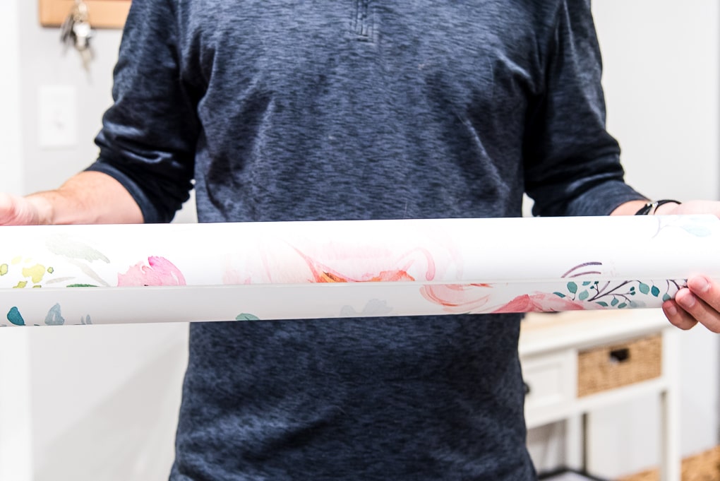 roll of spoonflower floral removable wallpaper being held