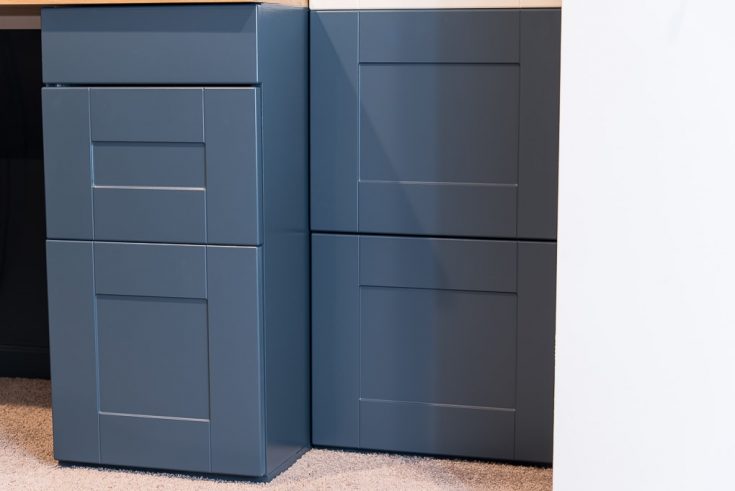 navy blue IKEA SEKTION cabinets installed in a built-in desk