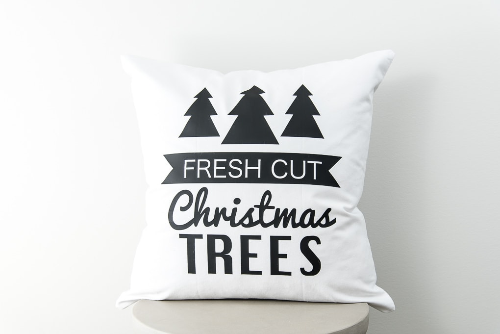 close up modern white pillow with black iron-on Christmas trees design