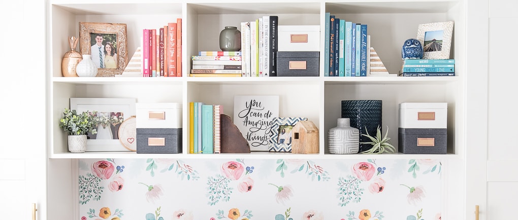 styled diy bookshelves with colorful books and picture frames