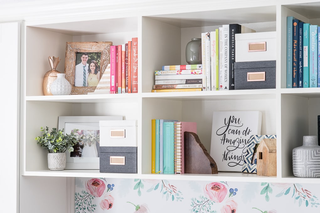 styled bookshelves with colorful books and picture frames