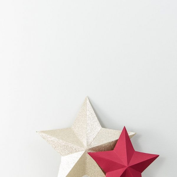 3D star decorations for Christmas red and gold glitter on table