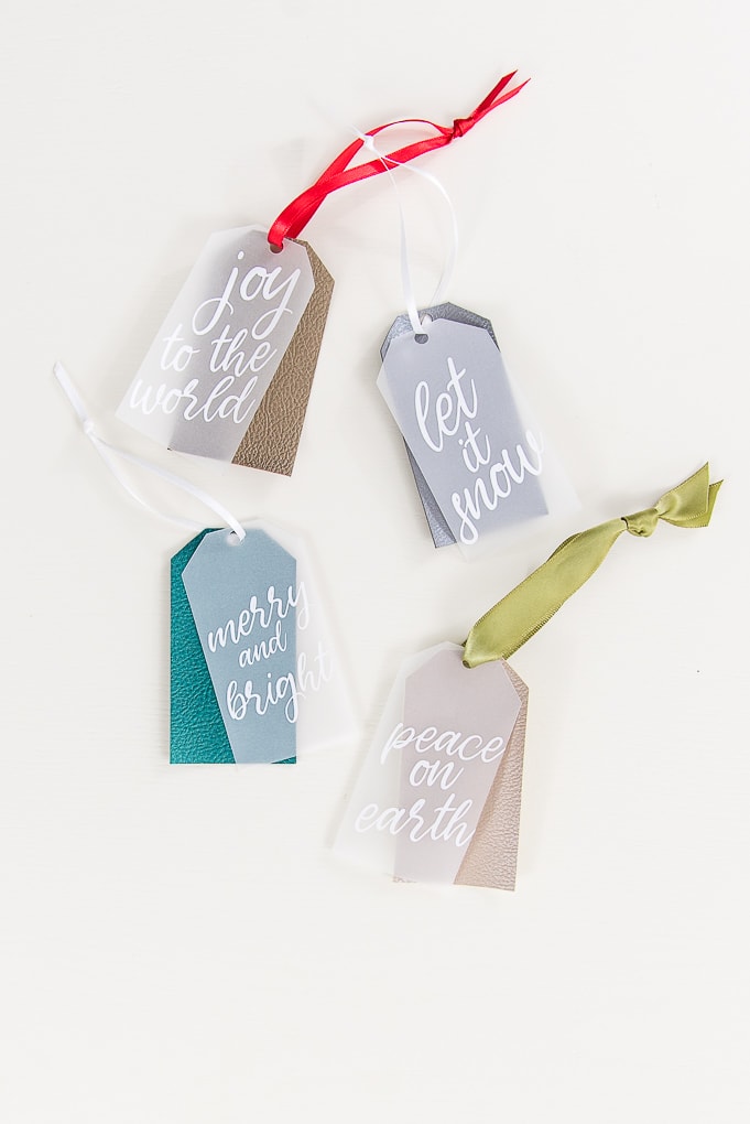 four layered Christmas gift tags with faux leather and vellum