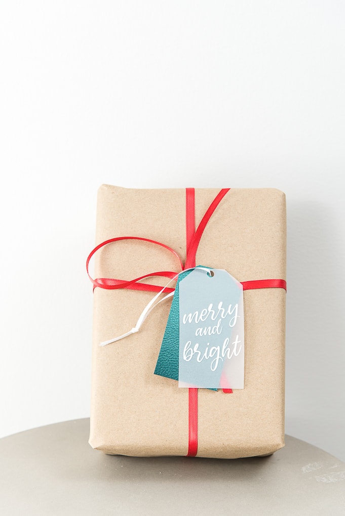 merry and bright layered gift tag on brown Christmas gift box