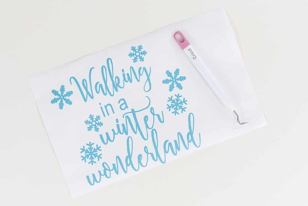 light blue vinyl walking in a winter wonderland design with weeder tool