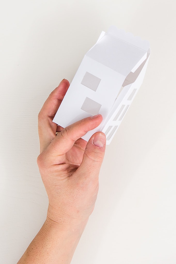 hand assembling paper 3D winter house
