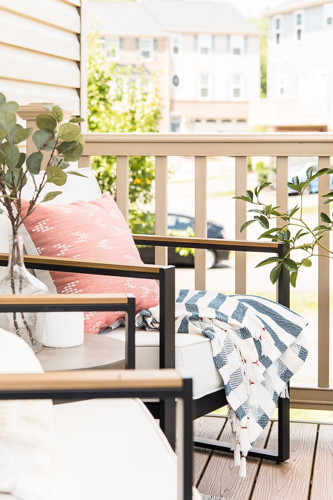 outdoor chair with pillow and blanket on porch