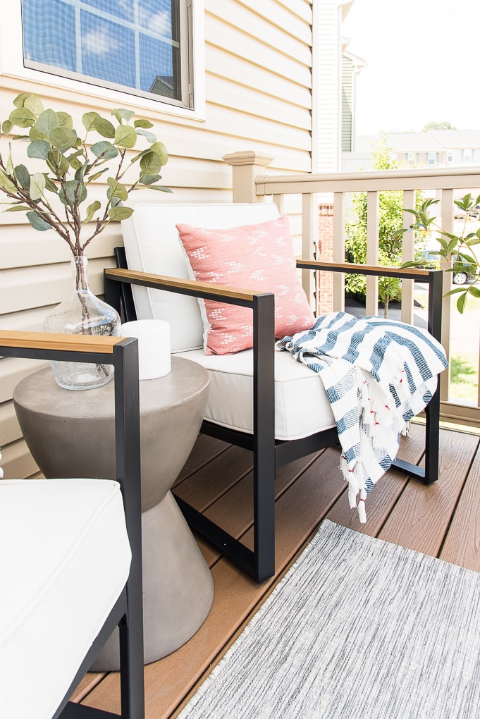 outdoor chair table and rug on outdoor porch