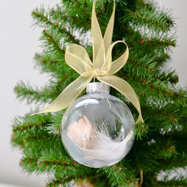 easy gold-dipped feather Christmas ornament on Christmas tree with gold ribbon bow