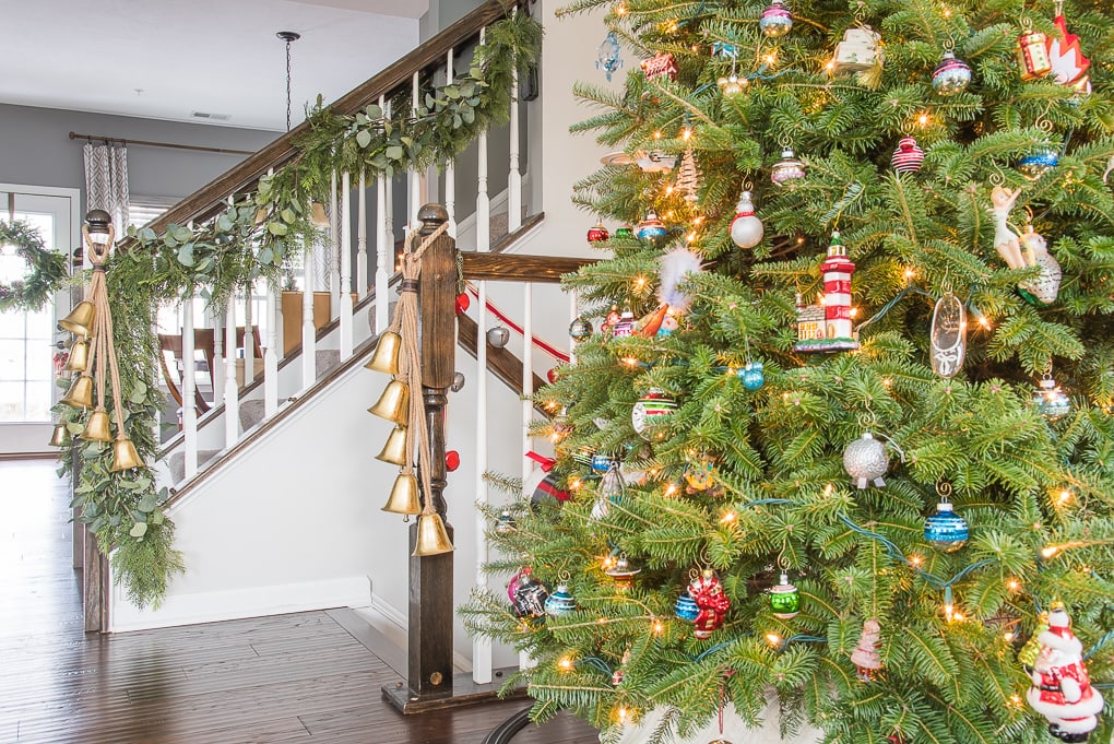 Fresh Christmas tree with family ornaments in modern classic home