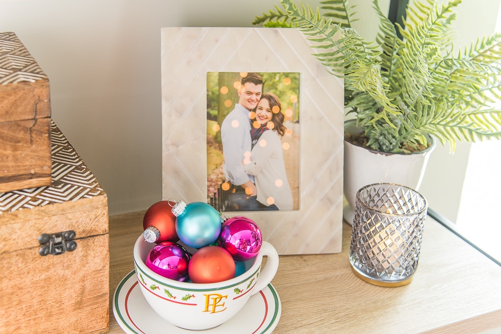 Colorful Christmas ornaments in hot chocolate mug