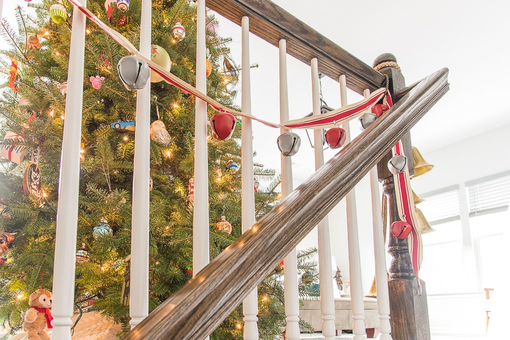 Red and white Christmas bell garland in front of tree