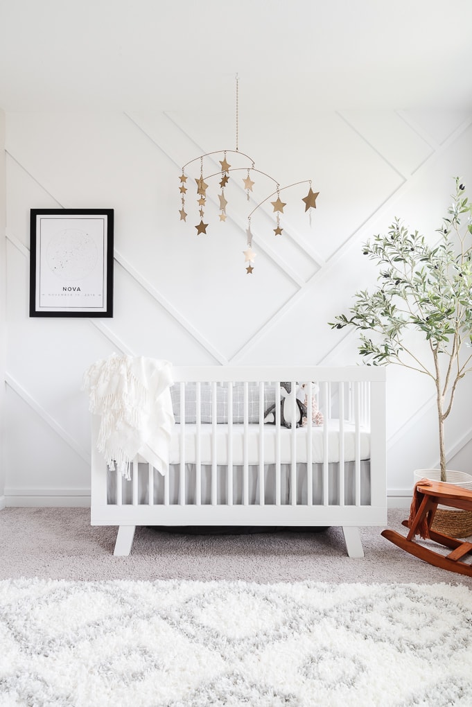 modern neutral nursery with a white crib and gold accents
