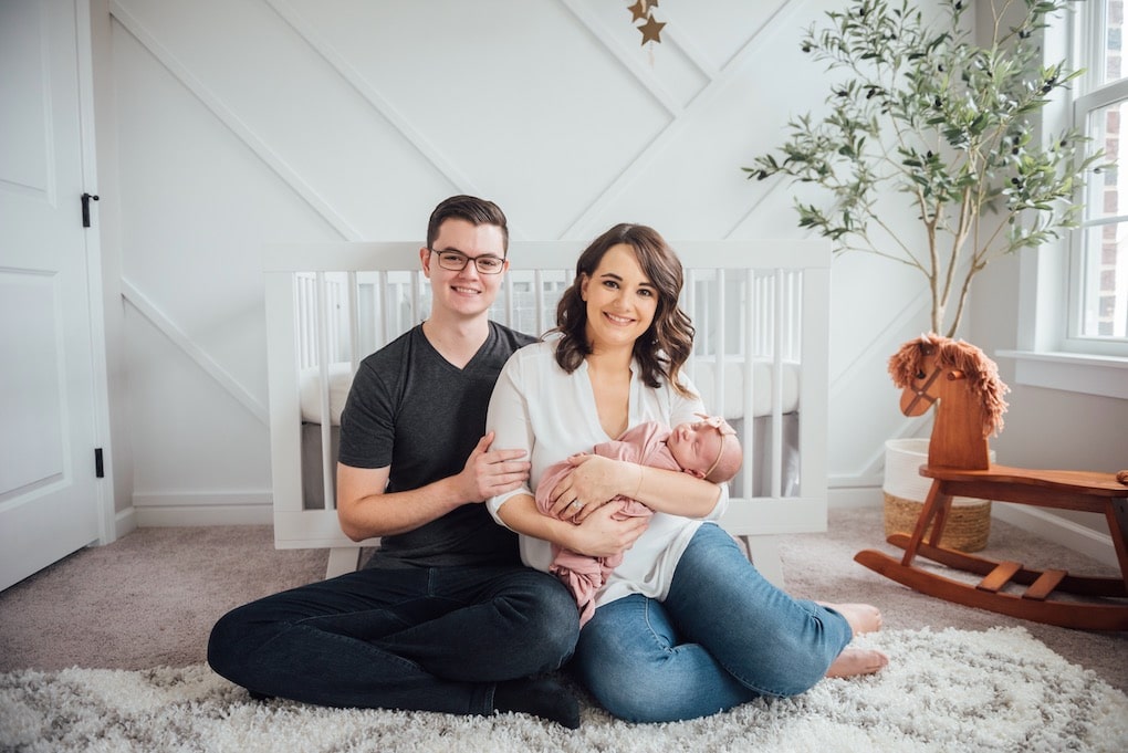 new family with new baby girl in modern neutral nursery mom dad and baby 