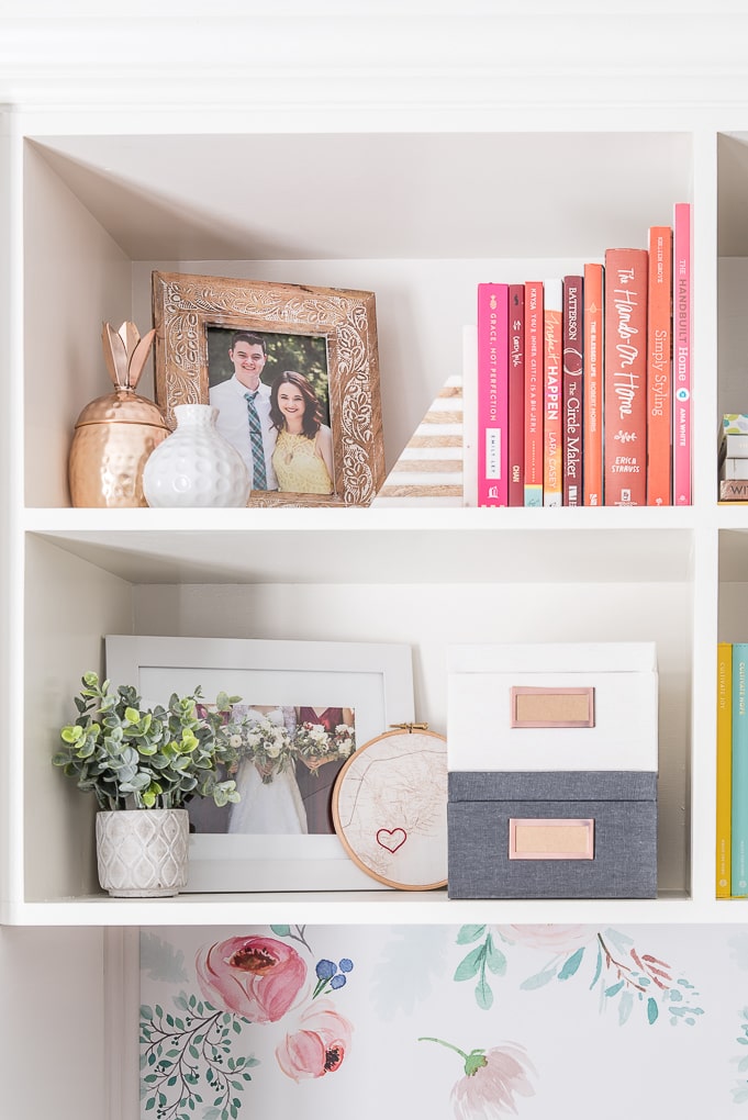 framed family photos on decorated bookshelves