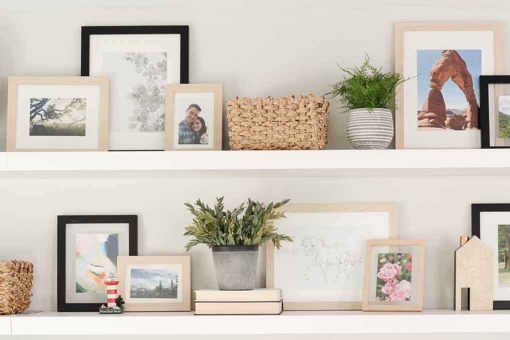 family photos printed in frames on shelves