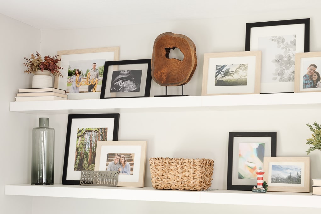 decorated shelves with printed and framed family photos