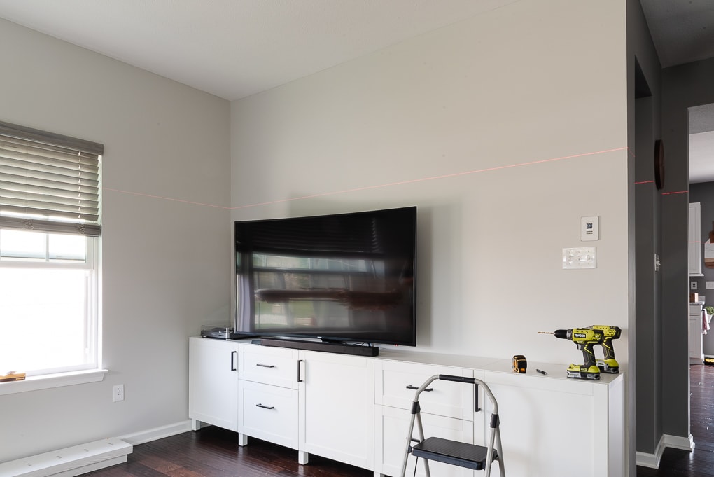 tv media center with empty wall and laser level line