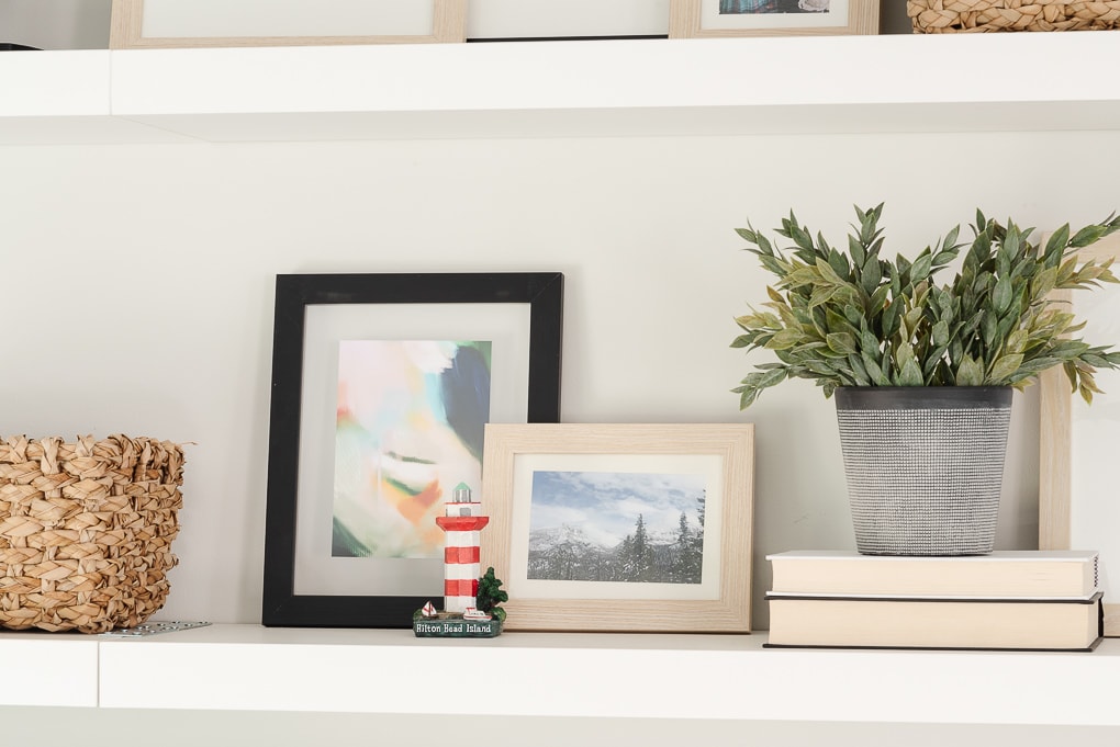 small photos framed on floating shelves