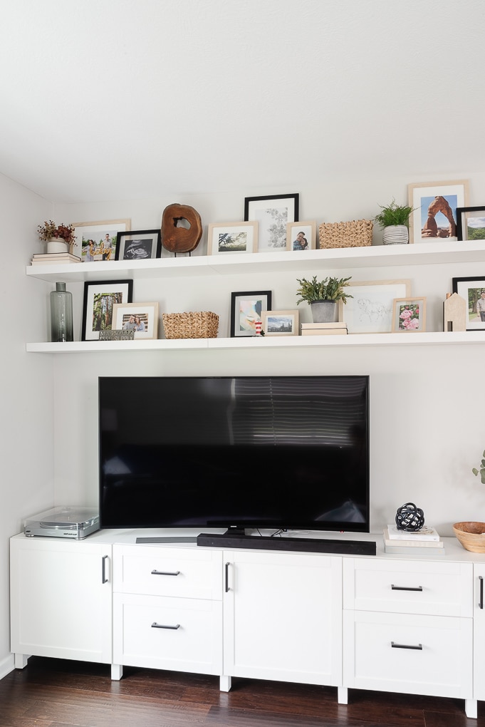 white living room media center and white floating shelves decorated