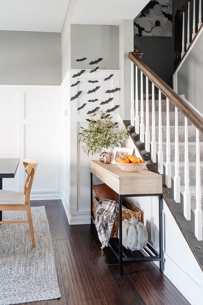 halloween bats decor above console table on white wall