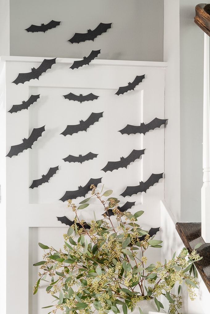 black halloween paper bats decor on white wall