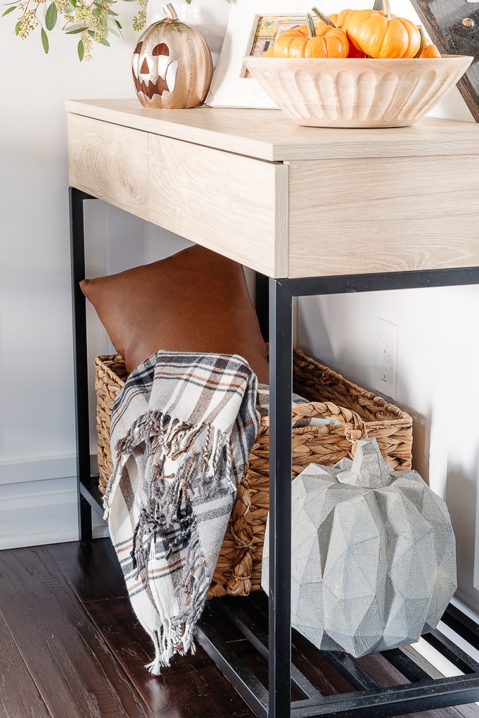 cement pumkin on console table shelf