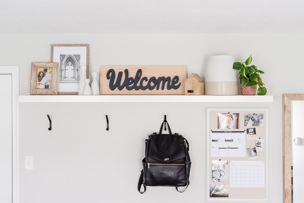 entryway hooks and decorated shelf