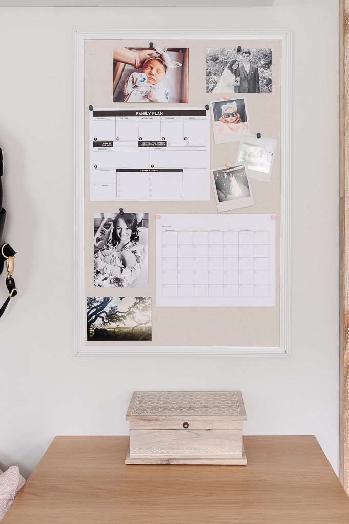 bulletin board with family photos and printables to make a command center